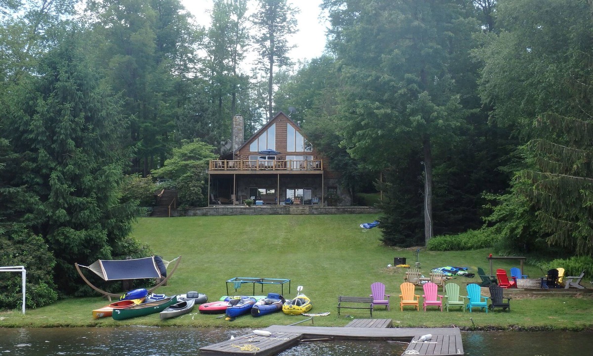 Treasure Lake House | Spacious Lakefront Log Home with large lakefront porch, firepit