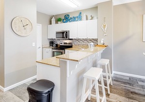Updated, beachside condo with dual suites, balcony & pool - walkable locale
