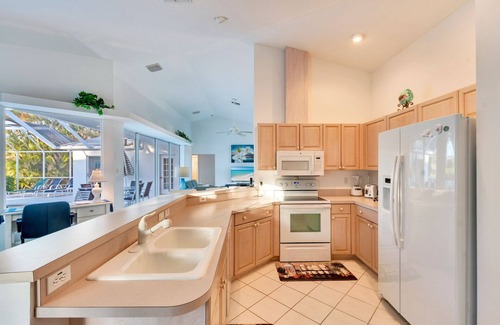 Central Naples House | Light and Bright describes this 3/2 Pool home with long beautiful lake views