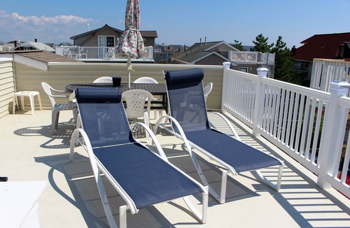 North End Condo | 4 bedroom/2 bath updated top floor with 3 DECKS just 7 houses from the beach!