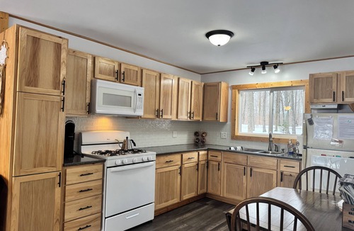 Birchwood House | Charming 2-bedroom cottage with WiFi, AC on quiet lake on trails with kayaks.