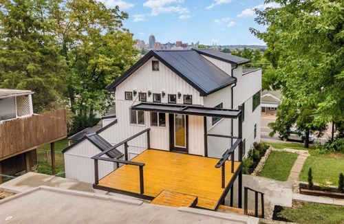 Covington House | Downtown skyline vista featuring giant rooftop deck & wet bar with a city view