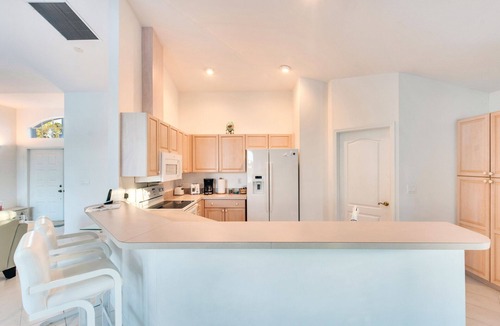 Central Naples House | Light and Bright describes this 3/2 Pool home with long beautiful lake views
