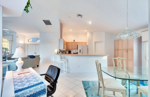 Central Naples House | Light and Bright describes this 3/2 Pool home with long beautiful lake views