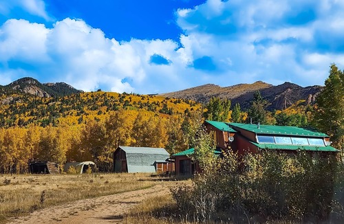 Cripple Creek House | Rustic home with mountain views, wood-burning stove, basketball court, & patio