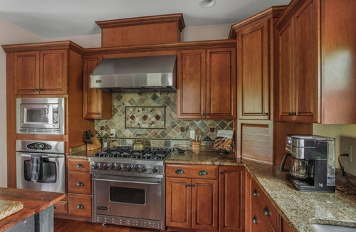 Huntly House | Secluded 4 bedroom log style home with screened porches, deck and fishing pond.