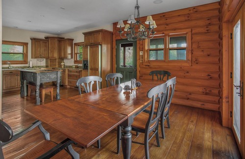 Huntly House | Secluded 4 bedroom log style home with screened porches, deck and fishing pond.
