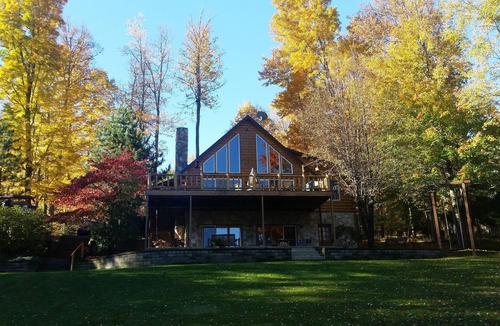Treasure Lake House | Spacious Lakefront Log Home with large lakefront porch, firepit