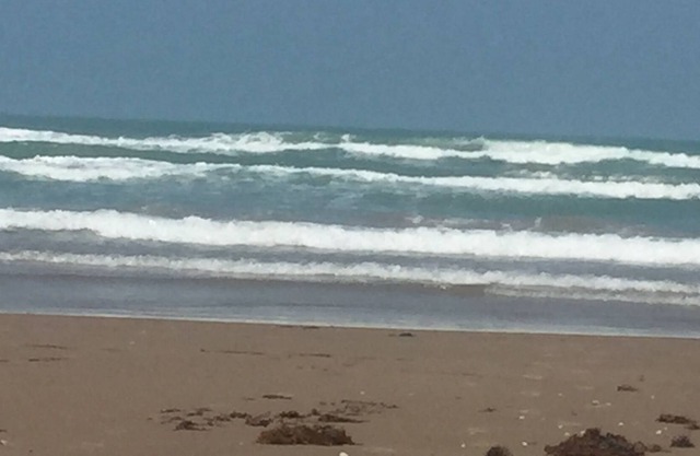 Beautiful condo with a modest view of the beach and only steps from beach access
