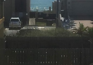 Beautiful condo with a modest view of the beach and only steps from beach access